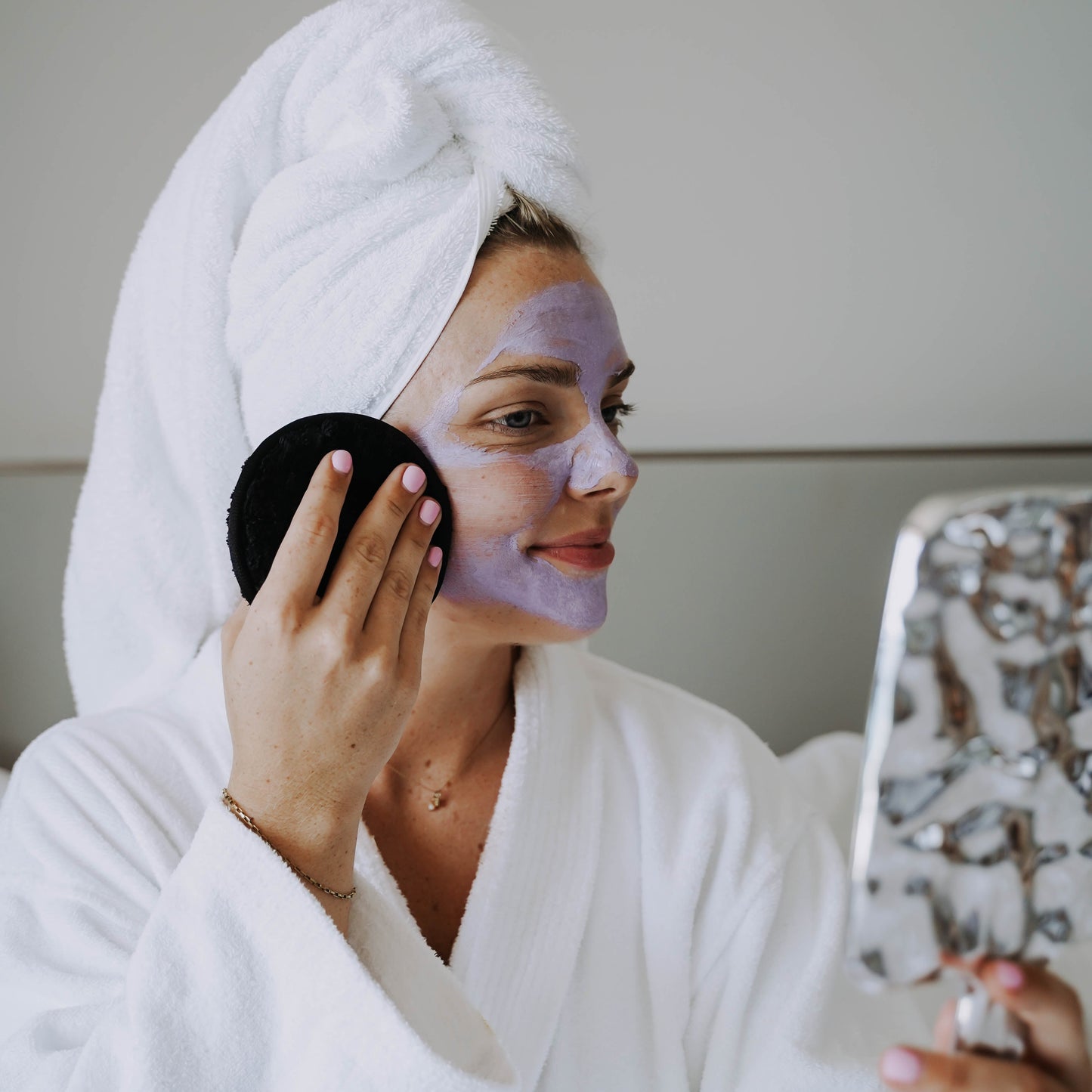Model cleansing skin with cleansing cloud. Model shot