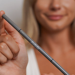 Brow pencil in hands, blurred background