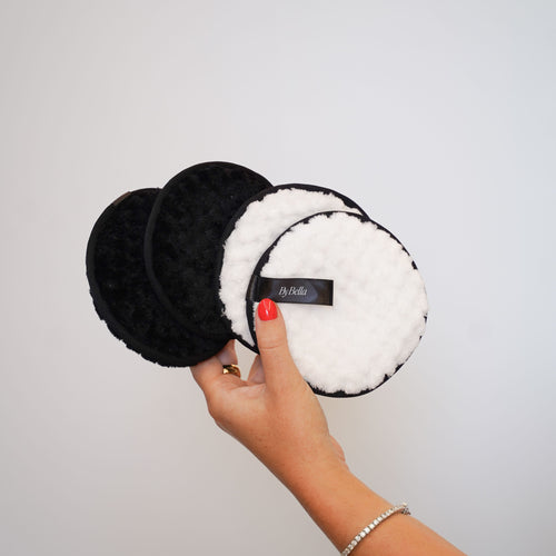 Cleansing clouds showing in 4 colours. Front view hand holding them 